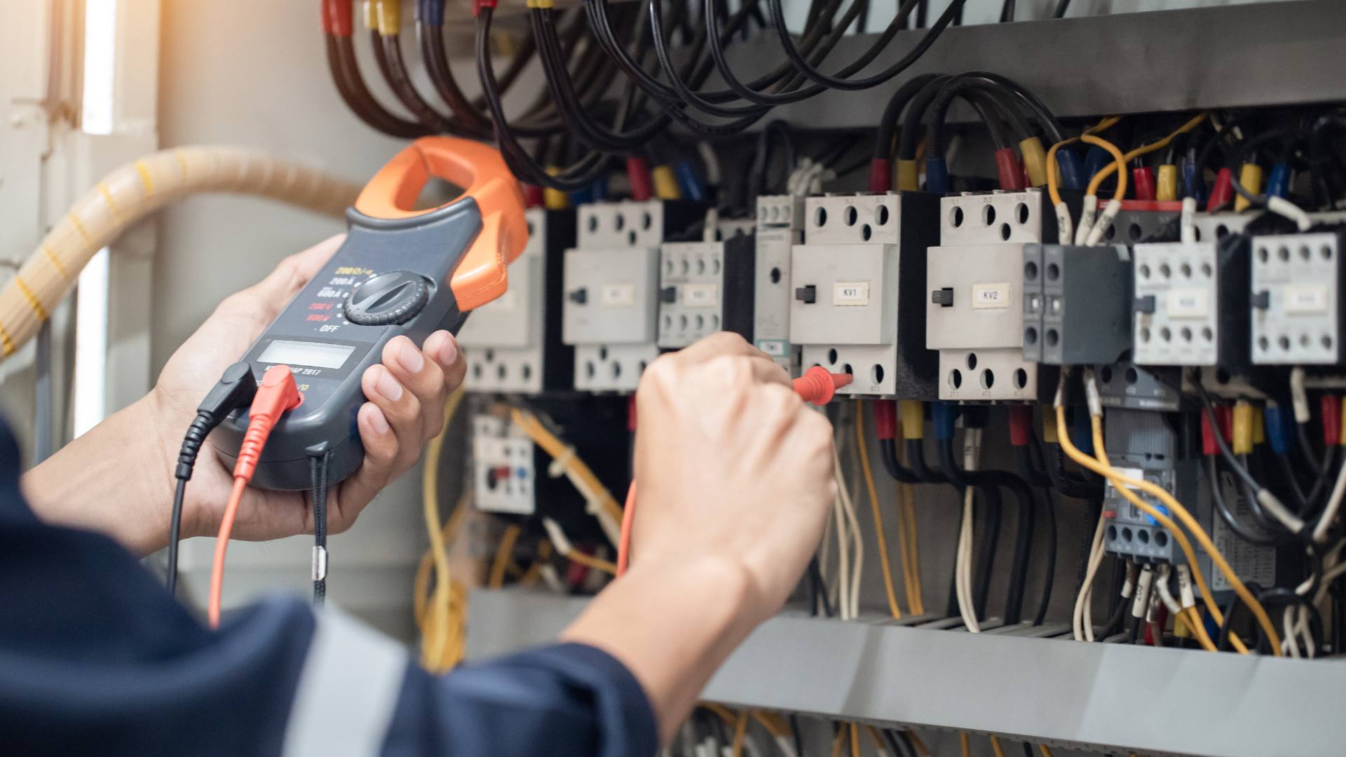 Electrician troubleshooting an electrical panel